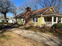 Charming yellow house with a spacious front yard and driveway at 506 S Love Chapel Rd, Stanfield, NC 28163