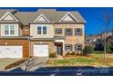 Two-story townhome with two-car garage and manicured lawn at 5110 Pansley Dr, Charlotte, NC 28226