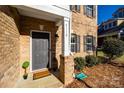 Gray front door with welcome mat and brick entryway at 5110 Pansley Dr, Charlotte, NC 28226