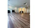 Spacious living room features hardwood floors, stone fireplace, and adjacent dining area at 5110 Pansley Dr, Charlotte, NC 28226
