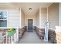 Inviting front entrance with stonework, a gray door, and a welcoming wreath at 5120 Kings Pinnacle Dr, Kings Mountain, NC 28086