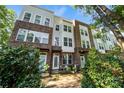 Brick townhome featuring a well maintained front yard and multiple windows at 547 Old Mill Rd, Charlotte, NC 28206