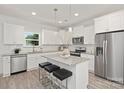 Modern kitchen featuring white cabinets, granite countertops, and stainless steel appliances at 8508 Sunflower Rd, Charlotte, NC 28227