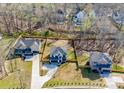 Aerial view of a neighborhood showcasing a modern two-story house with a well-maintained lawn at 1308 Pleasant Plains Rd, Matthews, NC 28105