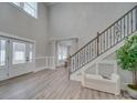 Bright foyer featuring staircase with decorative iron railing, with a large window and a stylish front door at 1312 Pleasant Plains Rd, Matthews, NC 28105