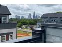 Rooftop view showcasing Charlotte's skyline beyond suburban rooftops and verdant trees, emphasizing urban proximity at 1312 Walter Taylor Way # Eqx0104, Charlotte, NC 28206