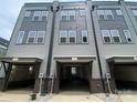 Modern townhouse exteriors with multiple garage entrances, showcasing modern architectural design and neutral gray color scheme at 1312 Walter Taylor Way # Eqx0104, Charlotte, NC 28206