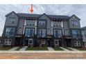 Modern townhome exterior features gray siding, brick accents, and a well-manicured lawn at 1320 Walter Taylor Way # Eqx0102, Charlotte, NC 28206