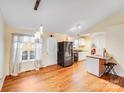 Spacious kitchen with stainless steel appliances, laminate flooring, and a breakfast bar at 150 Windmill Ct, Harmony, NC 28634