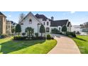 Elegant two-story home with a charming front entrance and landscaping at 18805 Flat Shoals Dr, Cornelius, NC 28031