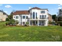 Luxury home with a large backyard, expansive patio, and lake views at 18805 Flat Shoals Dr, Cornelius, NC 28031
