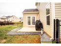 Small patio area with gravel and a grill in the backyard at 3458 Canyon Live Oak Ct, Gastonia, NC 28056