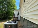 A ground level view of the home's rear and side exterior with an AC unit at 515 37Th Sw St, Hickory, NC 28602