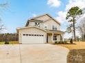 Charming two-story home boasts a spacious two-car garage and a well-manicured front yard at 5613 Morgan Mill Rd, Monroe, NC 28110