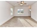 Spacious living room with modern gray flooring, recessed lighting, and large windows at 5613 Morgan Mill Rd, Monroe, NC 28110