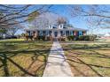 Front view of brick ranch home with mature trees at 101 Wynnchester Rd, Gastonia, NC 28056