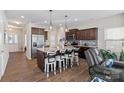 Modern kitchen with island, stainless steel appliances, and hardwood floors at 117 Fairfield Dr, Troutman, NC 28166