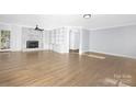 Bright living room with hardwood floors, fireplace, and built-in shelving at 12491 Oak Grove Rd, Stanfield, NC 28163