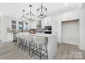 Bright, modern kitchen with white cabinets, a large island, pendant lighting and stainless steel appliances at 13019 Arnold Palmer Cir # 832, Lancaster, SC 29720