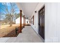 Welcoming front porch featuring stylish wood columns and a modern front door at 1306 Eddie St, Gastonia, NC 28054