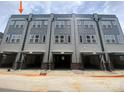 Rear view of contemporary townhomes with garage access, showcasing gray siding and ample windows at 1308 Walter Taylor Way # Eqx0105, Charlotte, NC 28206