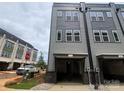 Open garage view of new construction townhome with brick accents and gray siding at 1308 Walter Taylor Way # Eqx0105, Charlotte, NC 28206