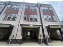 View of a covered townhome garage with neutral siding and brick accents at 1611 Polk St # Eqx0209, Charlotte, NC 28206