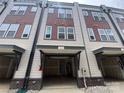 Attached one car garage of modern townhome featuring neutral gray color palette at 1615 Polk St # Eqx0208, Charlotte, NC 28206