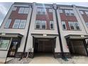 Modern townhome garages featuring updated siding, lighting and easy access at 1619 Polk St # Eqx0207, Charlotte, NC 28206