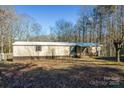 Mobile home exterior with wooden deck and steps at 3586 Bridle Path Dr, Vale, NC 28168