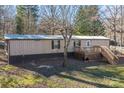 Mobile home exterior with wooden deck and steps at 3586 Bridle Path Dr, Vale, NC 28168