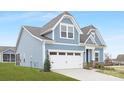 Side view of a charming two-story house with blue siding and a white garage door at 40242 Crooked Stick Dr # 1198, Lancaster, SC 29720