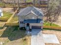 An aerial view shows the new construction home with an installed fence, a spacious yard, and a driveway at 1304 Pleasant Plains Rd, Matthews, NC 28105