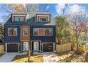 Modern two-unit building, navy and brown, with attached garages and fenced yards at 137 S Smallwood Pl, Charlotte, NC 28208