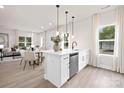 Open concept kitchen and dining area with white cabinets and breakfast bar at 1823 Bristol Rd, Statesville, NC 28677