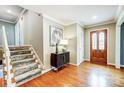 Hardwood staircase with runner and neutral wall colors at 3335 Knob Hill Ct, Charlotte, NC 28210