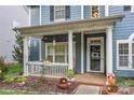 Inviting front porch with white columns and rocking chairs at 9243 Island Overlook Ct, Cornelius, NC 28031