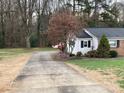 Long concrete driveway leading to a ranch house at 9608 Sunway Dr, Mint Hill, NC 28227