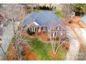 Brick home with a spacious yard and driveway at 1005 Woodhurst Dr, Monroe, NC 28110