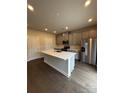 Modern kitchen features a large island, stainless steel appliances, and gray cabinets at 102 Alden Ct, Shelby, NC 28152