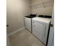 A compact laundry room featuring a white washer and dryer set with a wire shelf above at 102 Alden Ct, Shelby, NC 28152