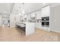 Modern kitchen featuring white cabinets, a large island, and stainless steel appliances at 13026 Arnold Palmer Cir # 1051, Lancaster, SC 29720