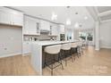 Modern kitchen with white cabinets, quartz countertops, and a large island at 13026 Arnold Palmer Cir # 1051, Lancaster, SC 29720
