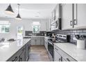 Modern kitchen with white countertops, gray cabinets, stainless steel appliances, and a center island at 3035 Howell Mill Rd # 51, Charlotte, NC 28208