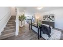Open concept living room showcasing modern decor and stairs leading to the upper level at 3035 Howell Mill Rd # 51, Charlotte, NC 28208