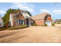 Brick home with a large yard and mature trees at 41166 Calla Lily St, Fort Mill, SC 29707