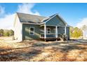 Charming single-story home with a covered front porch, featuring white columns and green siding at 528 Waco Rd, Kings Mountain, NC 28086