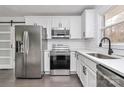 Renovated kitchen with stainless steel appliances and white cabinetry at 5442 Kinsale Ln, Charlotte, NC 28215