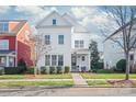 Charming two-story white home with a well-maintained lawn, landscaping, and inviting curb appeal at 1209 Cedar Park Dr, Pineville, NC 28134