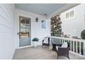 Relaxing front porch area with two chairs, a small table, and pleasant outdoor view at 1209 Cedar Park Dr, Pineville, NC 28134